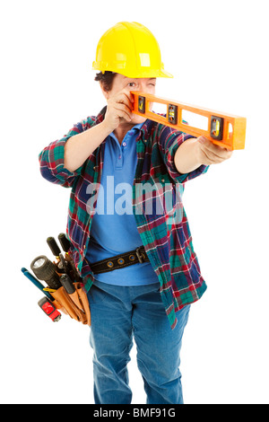 Female construction worker using a level. Isolated on white. Stock Photo