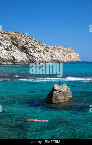 Young woman snorkelling with cormorant nearby Cala de Sant Vicenc Vicente Vincente bay in summer Majorca Mallorca Spain Europe B Stock Photo