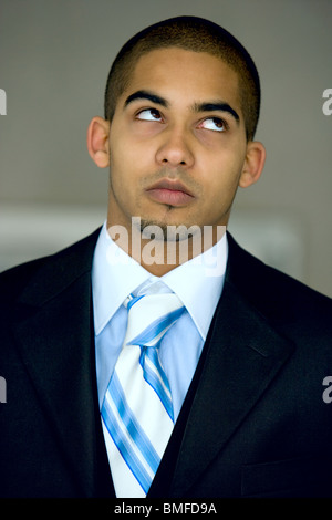 Young urban professional in his early 20's wearing a dark suit. Stock Photo