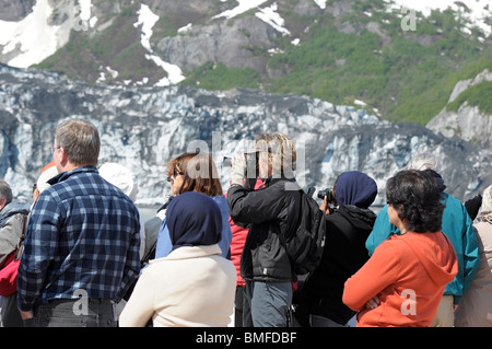 People aboard a cruise ship, looking at Glaciers and taking pictures.  Glacier Bay, Alaska. Stock Photo