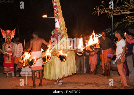 India, Kerala, Cannanore (Kannur), Theyyam, folk art ritual, Agni-Ghandakaran dancing in trance surrounded by flaming torches Stock Photo