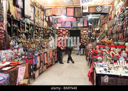 Clerks looking at camera in souvenir store, West Street, Yangshuo County, Guilin, Guangxi Province, China Stock Photo