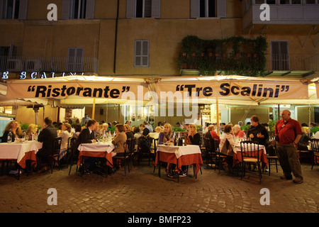 Typical restaurant pizzeria 'Tre Scalini' with people eating in the street. Piazza Navona Rome Italy Stock Photo