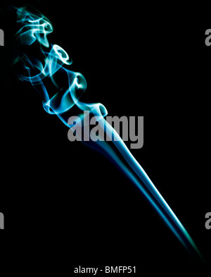 beautiful patterns created with the smoke of a bar of inciense and colorized over a black background Stock Photo