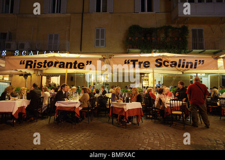 Typical restaurant pizzeria 'Tre Scalini' with people eating in the street. Piazza Navona Rome Italy Stock Photo