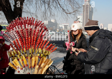 Street vendor selling traditional snack Tanghulu, Jilin, Jilin Province, China Stock Photo