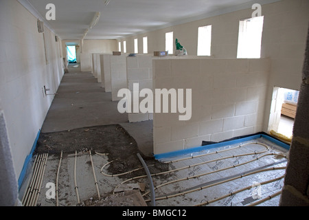 Installing underfloor heating pipes in new kennels building Cheltenham UK Stock Photo