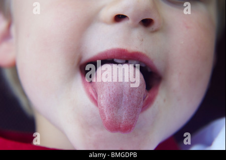 toddler boy poke out tongue Stock Photo - Alamy