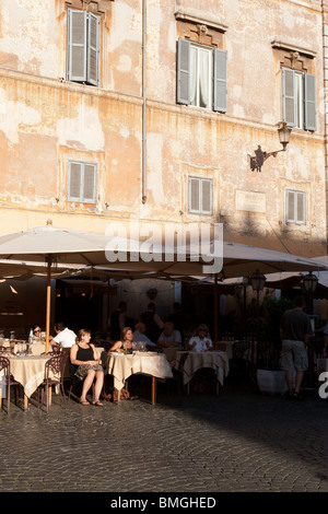 Person sit in a traditional bar in Santa Maria in Trastevere square Rome Italy Stock Photo