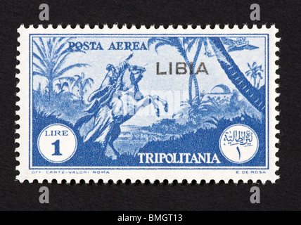 Postage stamp from Tripolitania depicting horseman pointing at an airplane, overprinted for use in Libya Stock Photo