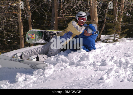 Snowboarders laying in snow. Stock Photo