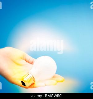 Background with lit lightbulb; Isolated on blue Stock Photo