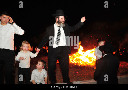 Israel, Haifa, Neve Shaanan, Jews dance around the bonfire during the lag b'omer celebrations. Stock Photo