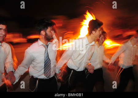 Israel, Haifa, Neve Shaanan, Jews dance around the bonfire during the lag b'omer celebrations. Stock Photo