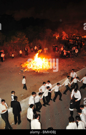 Israel, Haifa, Neve Shaanan, Jews dance around the bonfire during the lag b'omer celebrations. Stock Photo