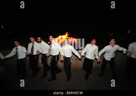 Israel, Haifa, Neve Shaanan, Jews dance around the bonfire during the lag b'omer celebrations. Stock Photo