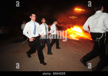 Israel, Haifa, Neve Shaanan, Jews dance around the bonfire during the lag b'omer celebrations. Stock Photo