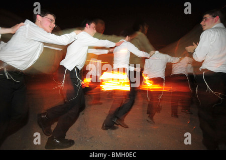 Israel, Haifa, Neve Shaanan, Jews dance around the bonfire during the lag b'omer celebrations. Stock Photo