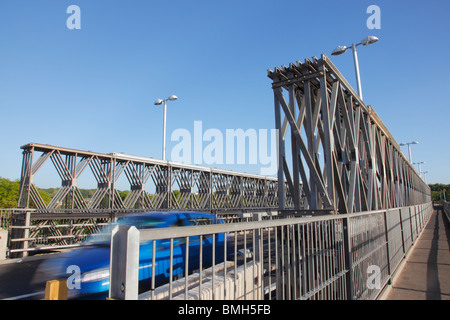 Workington temporary road bridge over the river Derwent. Which blurred blue car passing. Stock Photo