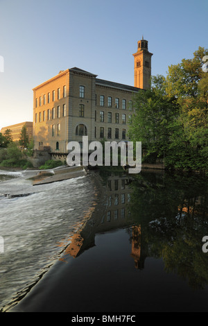 A view of New Mill, at Salts Mill, Saltaire, reflected in the River Aire, Bradford, West Yorkshire Stock Photo