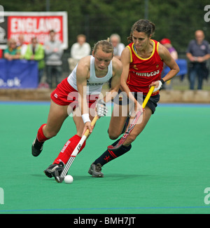 Two players contesting the ball in womens hockey Stock Photo