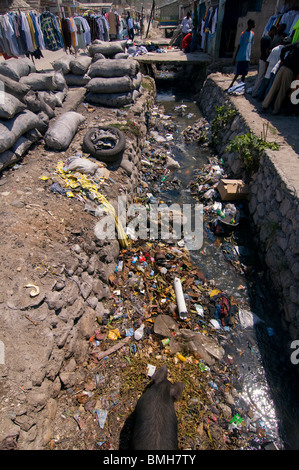 Street  scene in Port au Prince showing an incomplete drainage canal filled with rubbish. Haiti Stock Photo