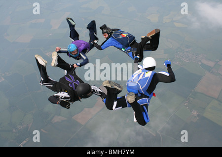 Four skydivers forming a circle while in freefall Stock Photo