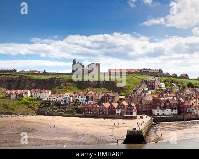 Whitby beach, Abbey and church above the harbour entrance at Whitby, North Yorkshire, England, UK Stock Photo