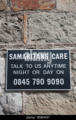 A plaque advertising the Samaritans phone number on the tower of the Clifton Suspension Bridge. Bristol, England. Stock Photo