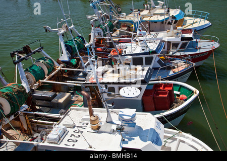A row of small fishing boats moored in the harbour at Boulogne-sur-Mer in the Pas-de-Calais region of France. Stock Photo