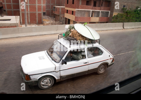 small overloaded car on a road in cario egypt Stock Photo