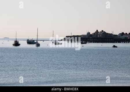 moored boats in Swanage Bay in the early morning light Stock Photo