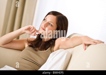 Young woman relax in lounge on sofa Stock Photo