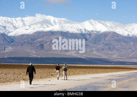 Tourists walking on Badwater Basin. Lowest point in the United States. Death Valley National Park, California. Stock Photo