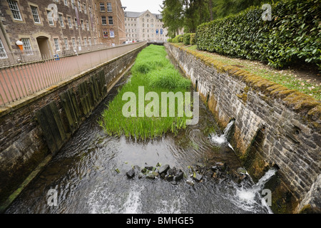 New Lanark - Robert Owen's utopian industrial village in Scotland. The canal for the mill wheel (millrace). Stock Photo