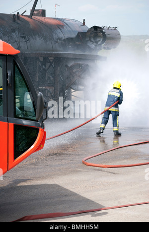 firefighter training with simulated aircraft fire Stock Photo