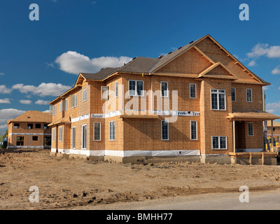 Wooden-frame two-story house with OSB sheathed walls under construction. Milton, Ontario, Canada. Stock Photo