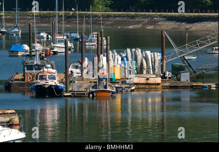 Mariner jetty with small boats and piles reflected in the water. Stock Photo