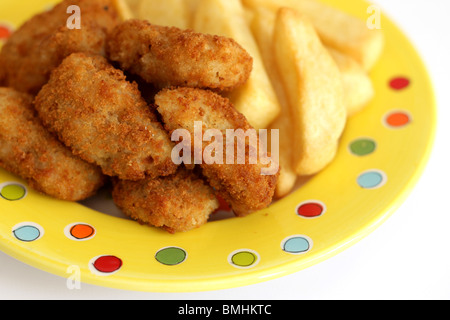 Freshly Cooked Or Prepared Breaded Scampi Tails With Chips Or Fries Served On A Plate With No People Stock Photo