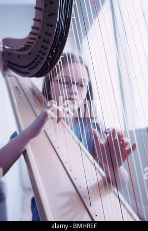 Young girl playing the harp Stock Photo