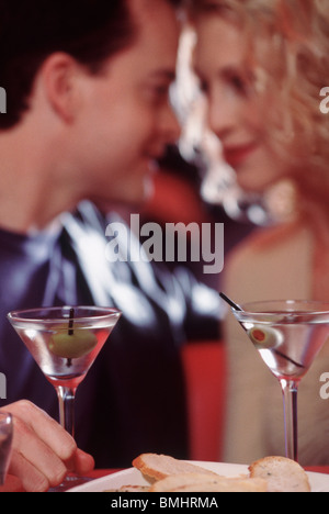 Couple drinking martinis in a restaurant Stock Photo