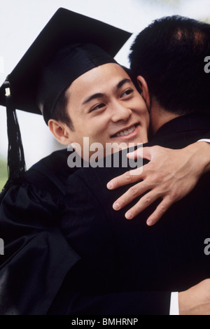 Graduate embracing his father Stock Photo