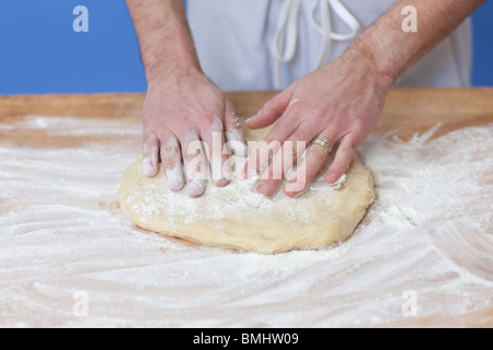 Man's hands kneading bread dough Stock Photo
