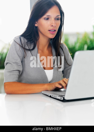 Woman typing on laptop Stock Photo