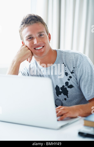 Young man working on laptop Stock Photo
