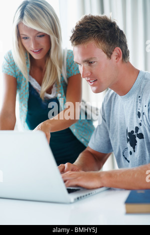 College students looking at laptop Stock Photo