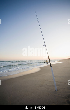 Sandy beach with surf fishing rods on a sunny day Stock Photo - Alamy