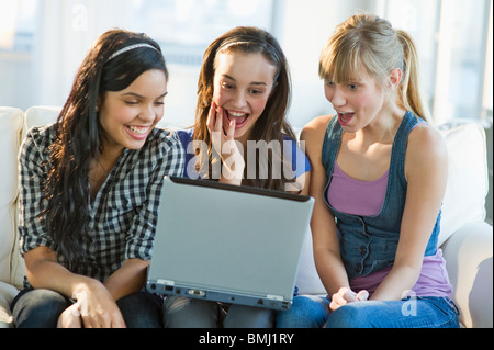 Friends looking at laptop Stock Photo