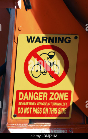 Sign on a large lorry warning cyclists not to overtake when lorry is turning left. Stock Photo