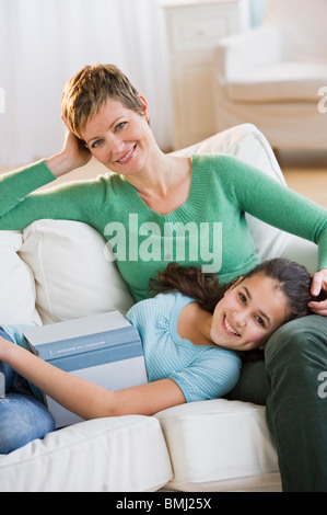 Mother and daughter relaxing on couch Stock Photo